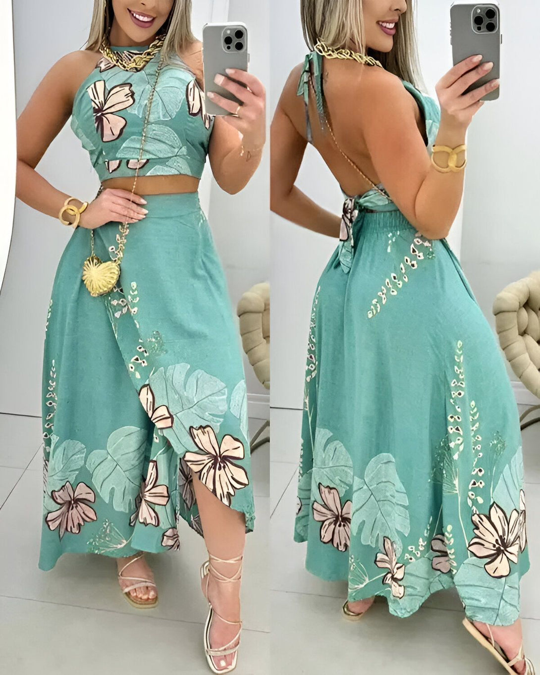 Une femme porte un ensemble deux pièces vert avec des motifs de fleurs et de feuilles. Le haut est un crop top et la jupe est longue et fendue sur le côté. Elle porte également un collier doré et des sandales dorées.
