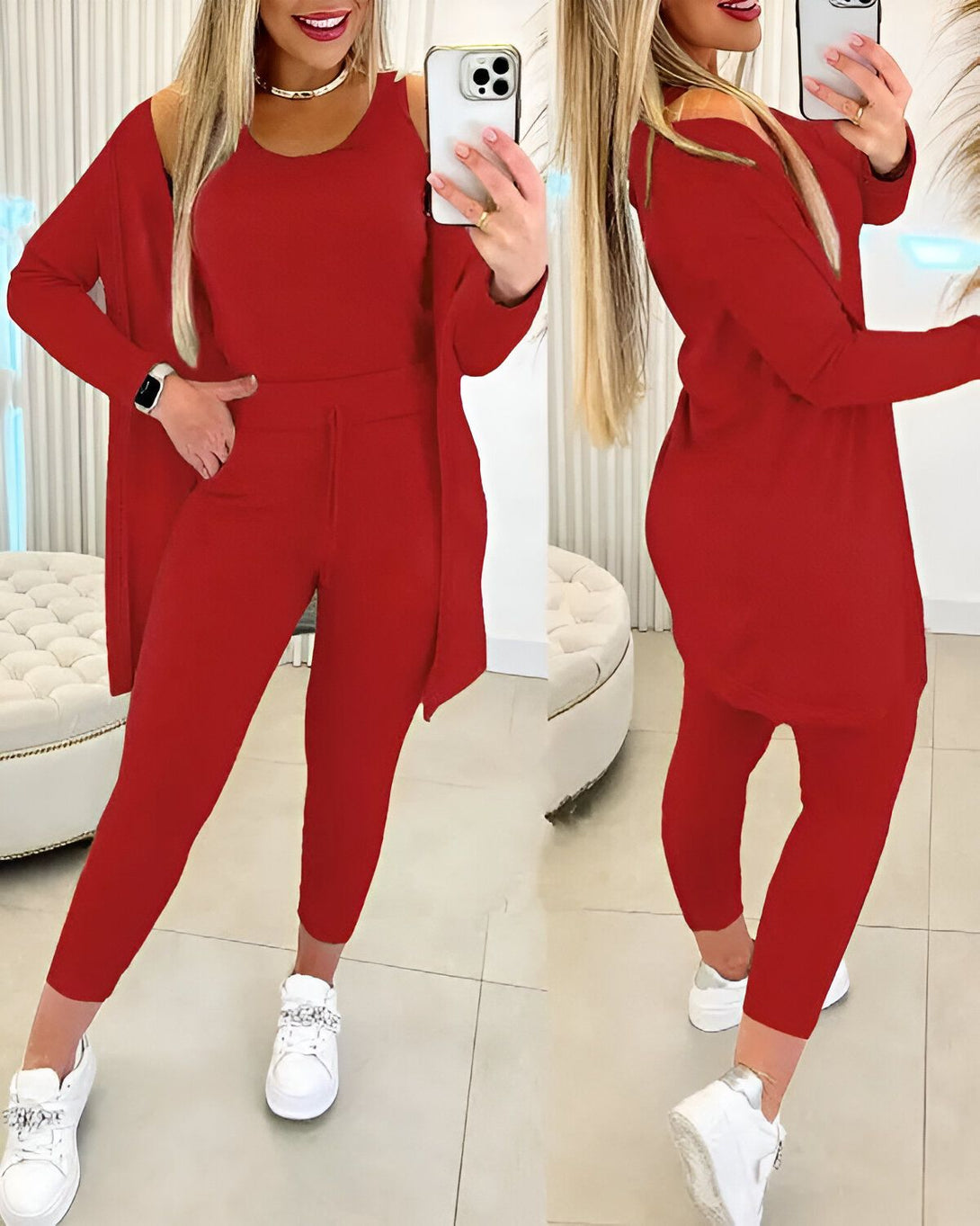 Une femme porte un ensemble pantalon et veste rouge. Elle est également chaussée de baskets blanches.