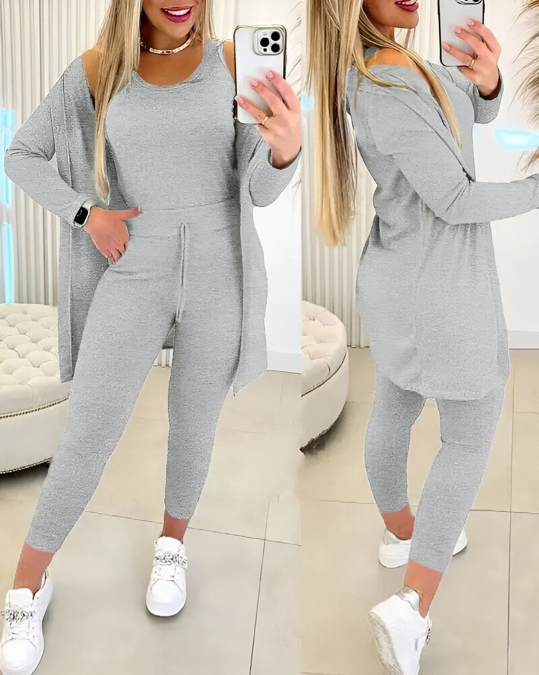 Une femme porte un ensemble de jogging gris composé d'un débardeur, d'un pantalon et d'un cardigan. Elle est debout devant un miroir et se prend en photo.