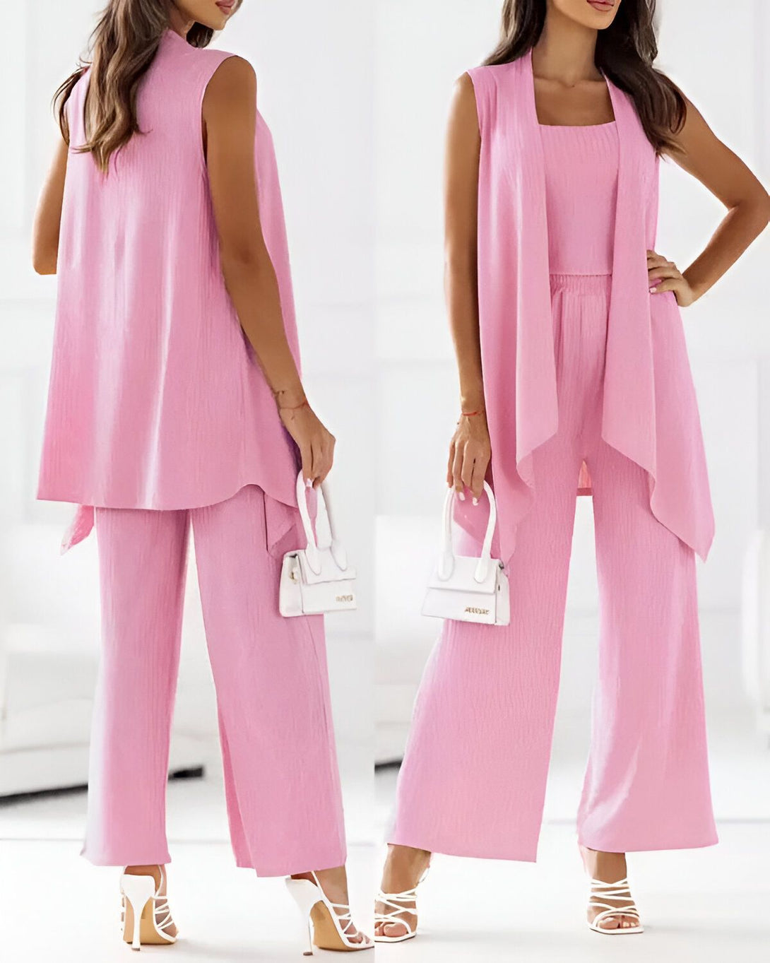 Une femme porte un ensemble trois pièces rose composé d'un gilet, d'un pantalon et d'un top. Le gilet est long et ample, le pantalon est large et le top est court et ajusté. La femme porte des sandales à talons hauts et un sac à main blanc.