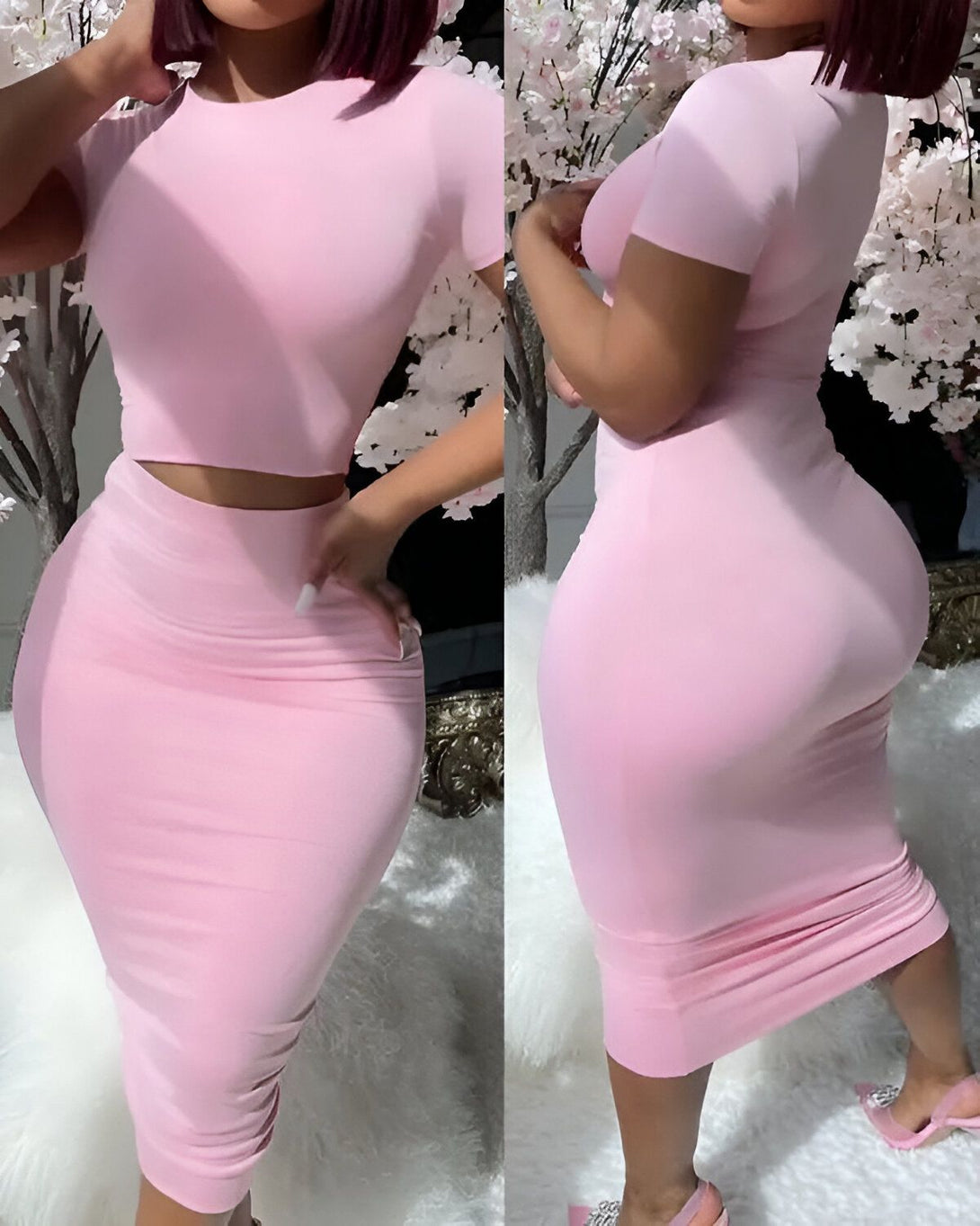 Une femme porte un ensemble deux pièces rose composé d'un crop top à manches courtes et d'une jupe moulante.