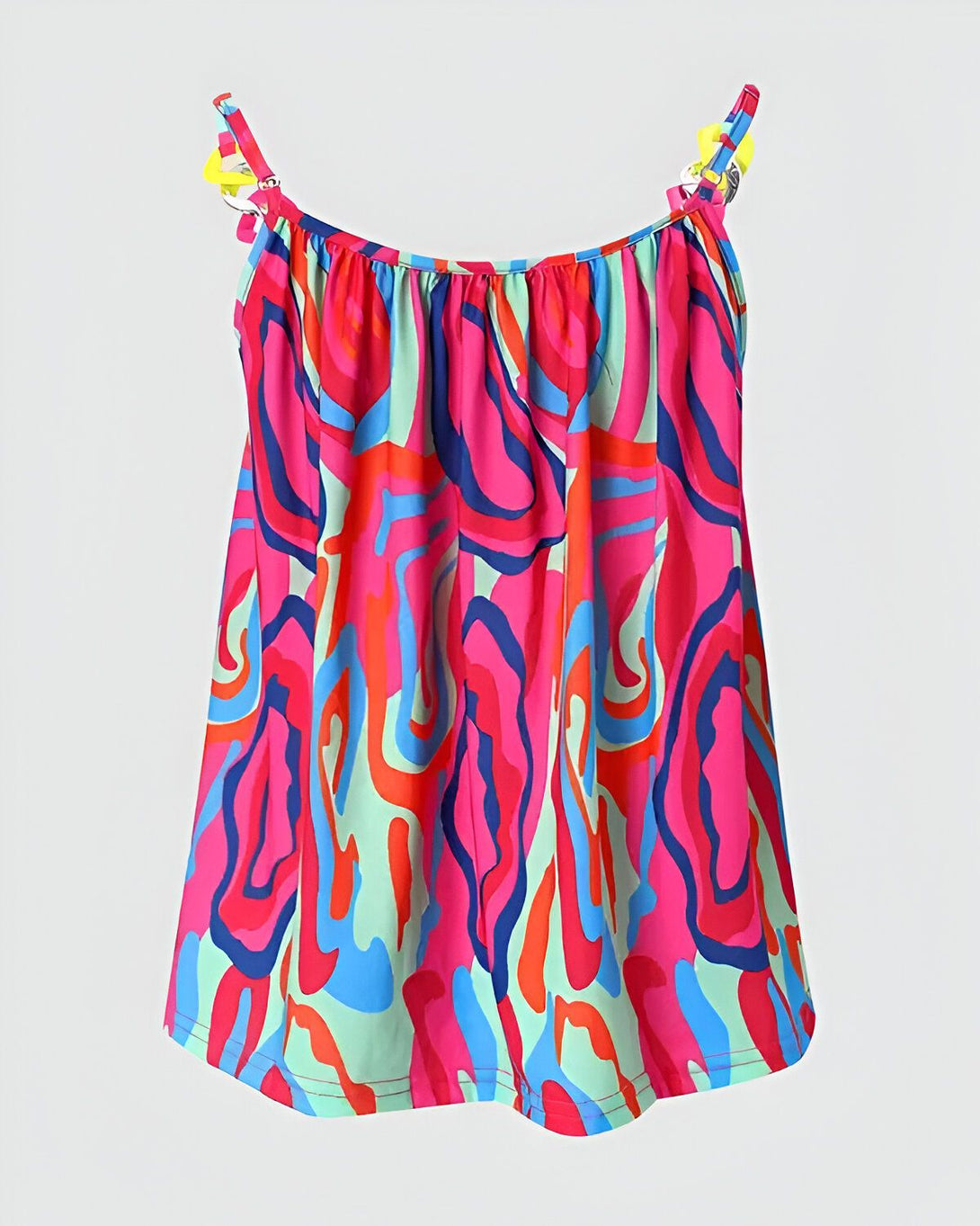 Une image d'une robe d'été colorée avec des motifs abstraits. La robe est rose, verte, bleue et orange.