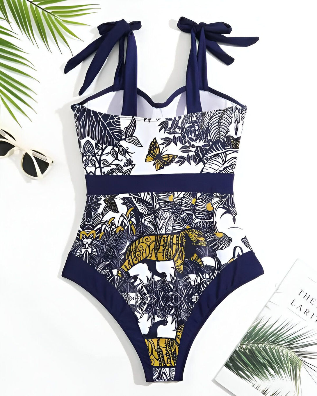 Maillot de bain une pièce avec imprimé jungle et nœuds sur les épaules.
