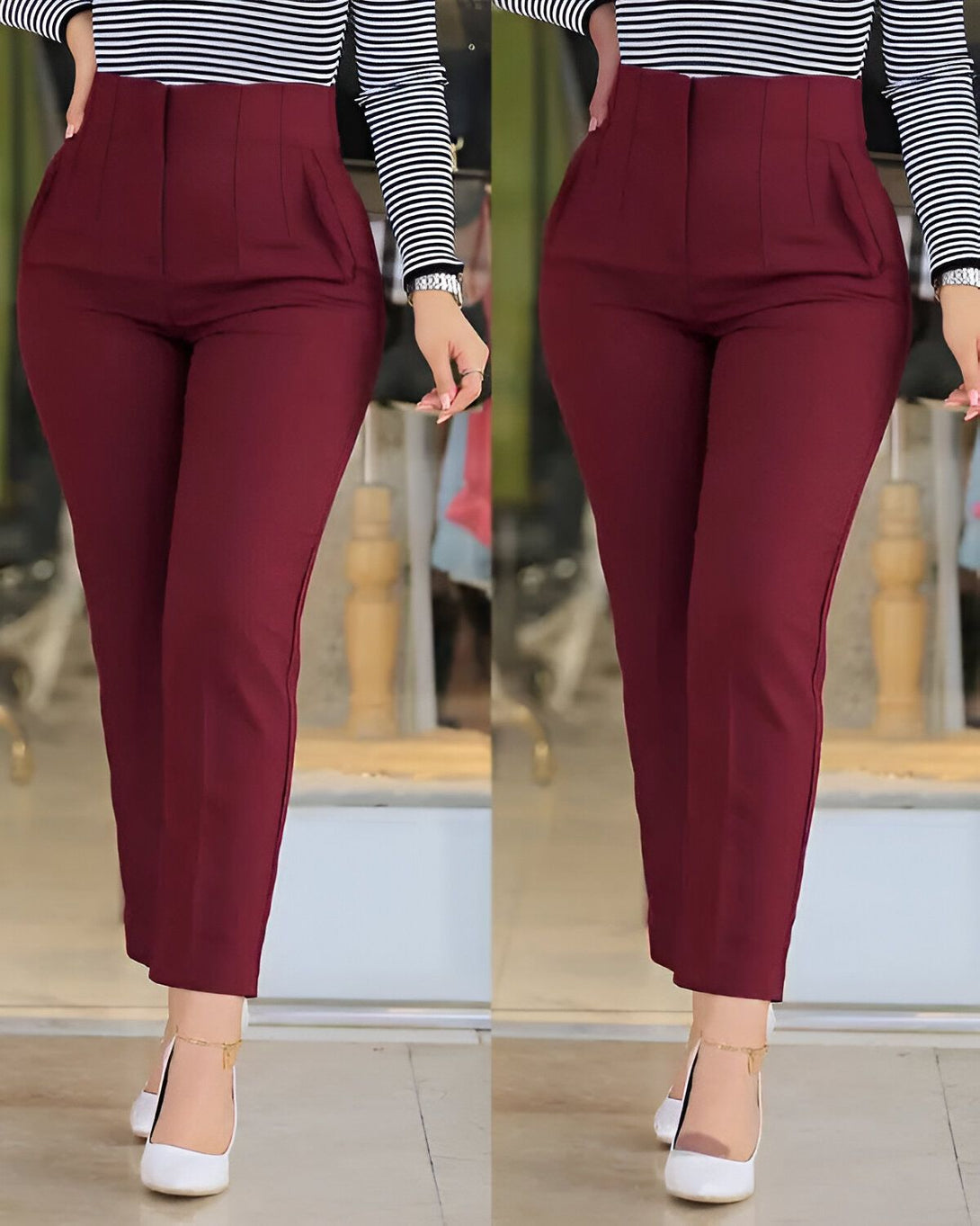 Une femme porte un pantalon taille haute rouge bordeaux et un chemisier rayé noir et blanc. Elle est debout, les mains sur les hanches. Le pantalon est près du corps et a une coupe droite. Il est parfait pour une journée au bureau ou une soirée en ville.