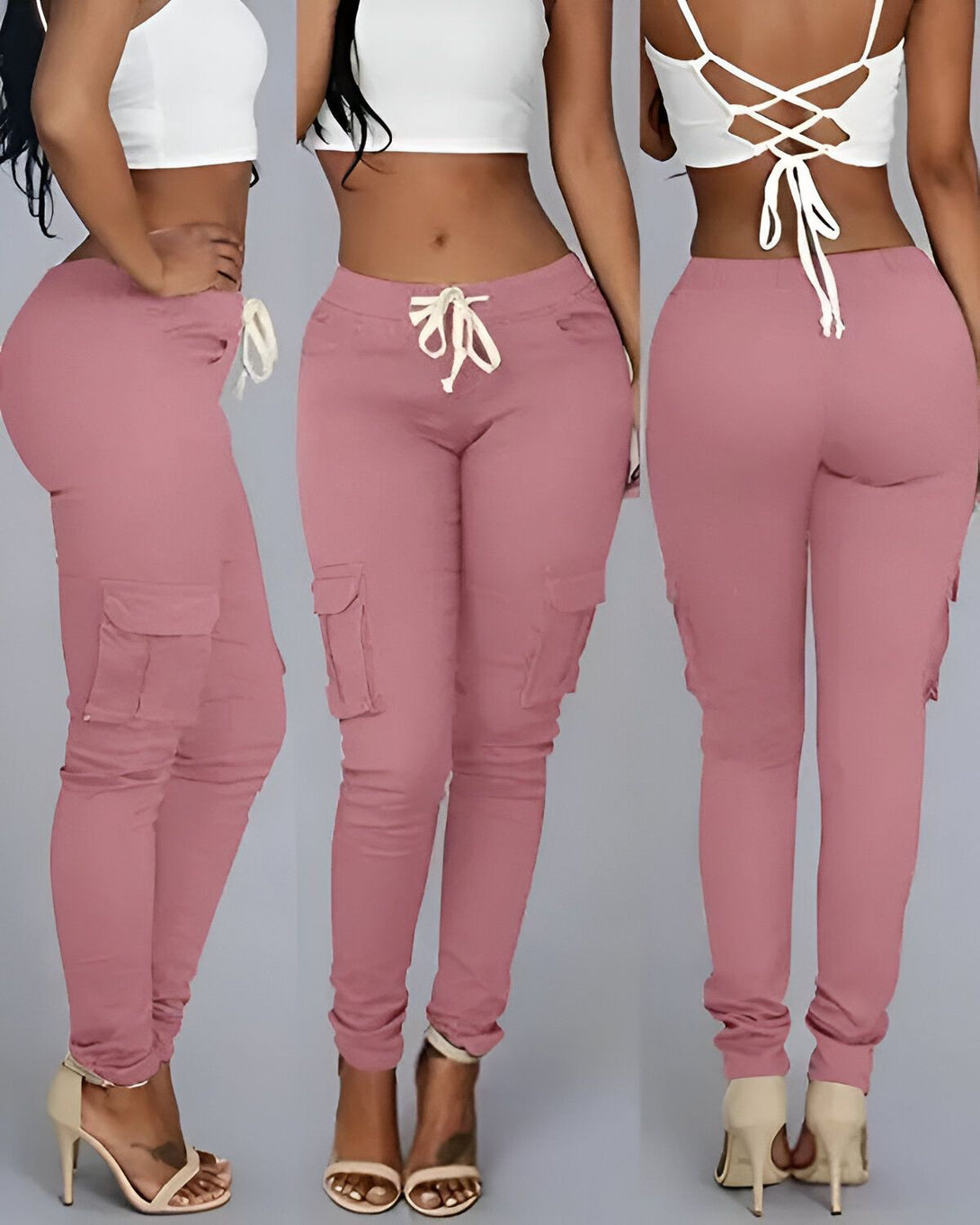 Une femme porte un pantalon cargo rose moulant avec un haut blanc. Le pantalon a des poches sur les côtés et des cordons de serrage à la taille.