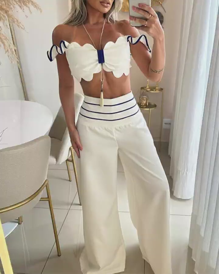 Video d'une femme portant : Ensemble haut à épaules dénudées et pantalon large rayé à bordure festonnée