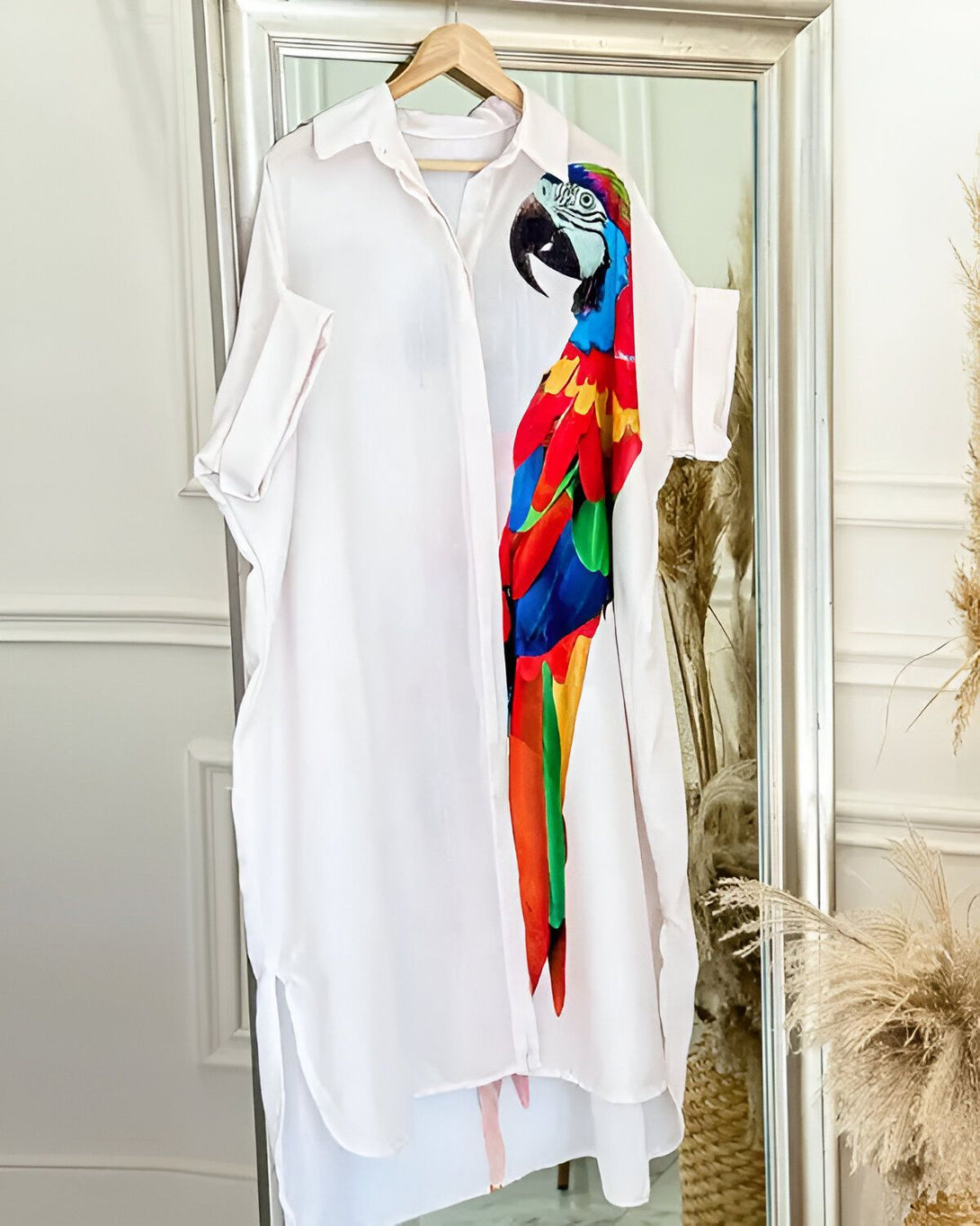 Une chemise blanche avec un perroquet coloré imprimé dessus.