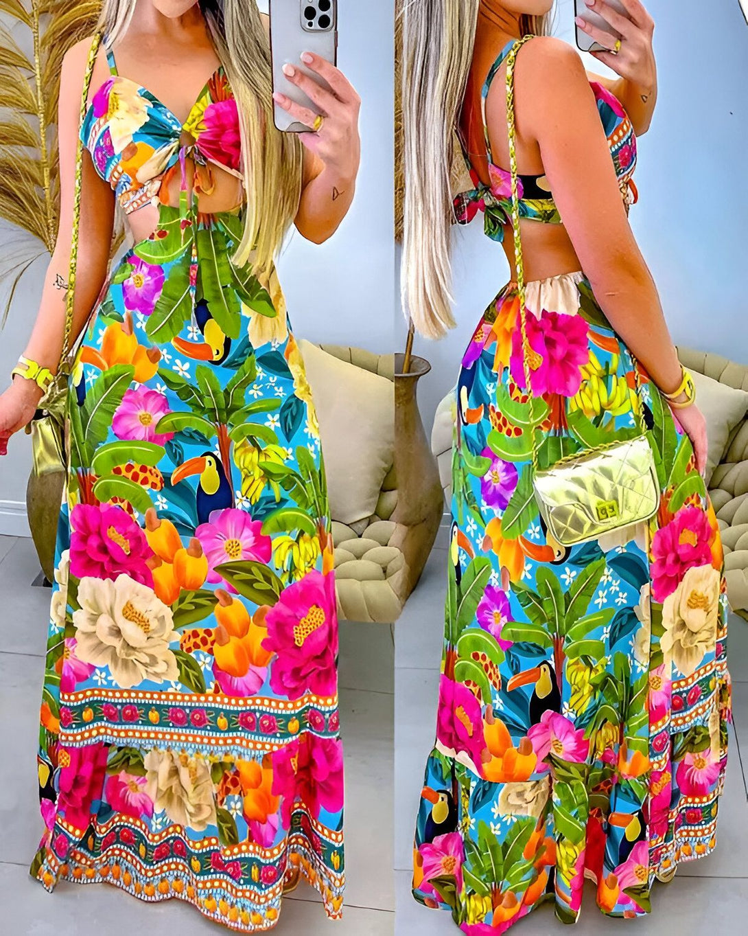 Une femme porte une robe longue colorée avec un imprimé tropical. La robe est décolletée et nouée au niveau de la poitrine. Elle est fendue sur les côtés et possède une taille haute. La femme porte également un sac à main doré et des sandales.