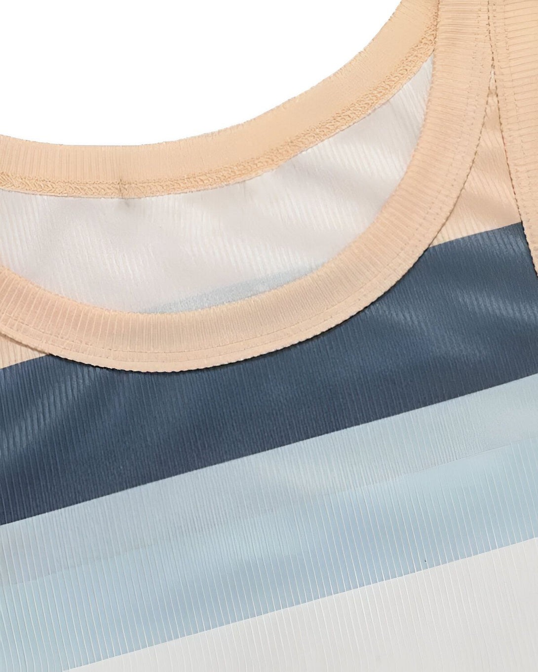 L'image montre un débardeur de couleur beige, bleu marine et bleu clair. Le débardeur est côtelé et possède une encolure ronde.
